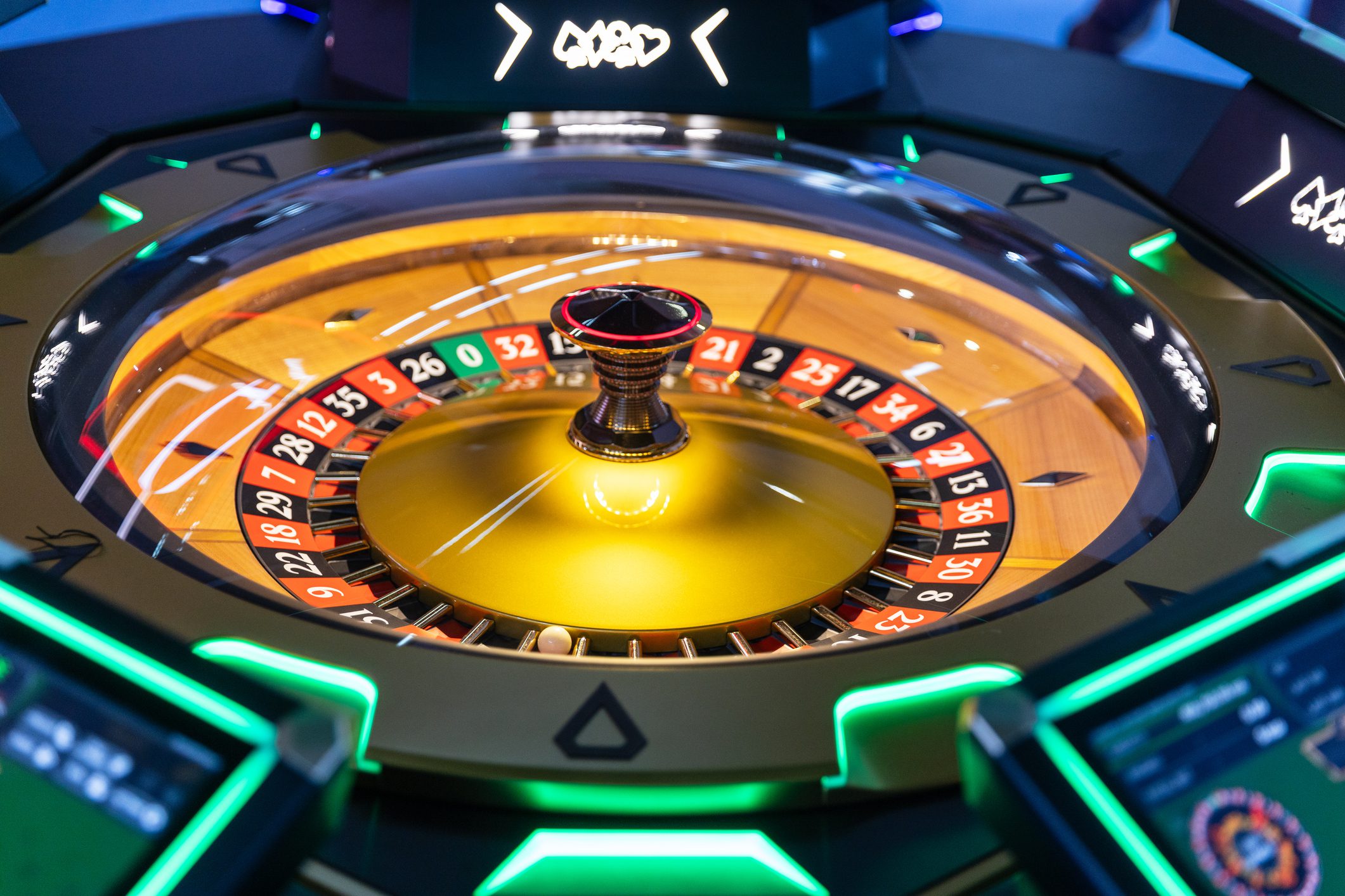 Casino roulette wheel with glowing lights.