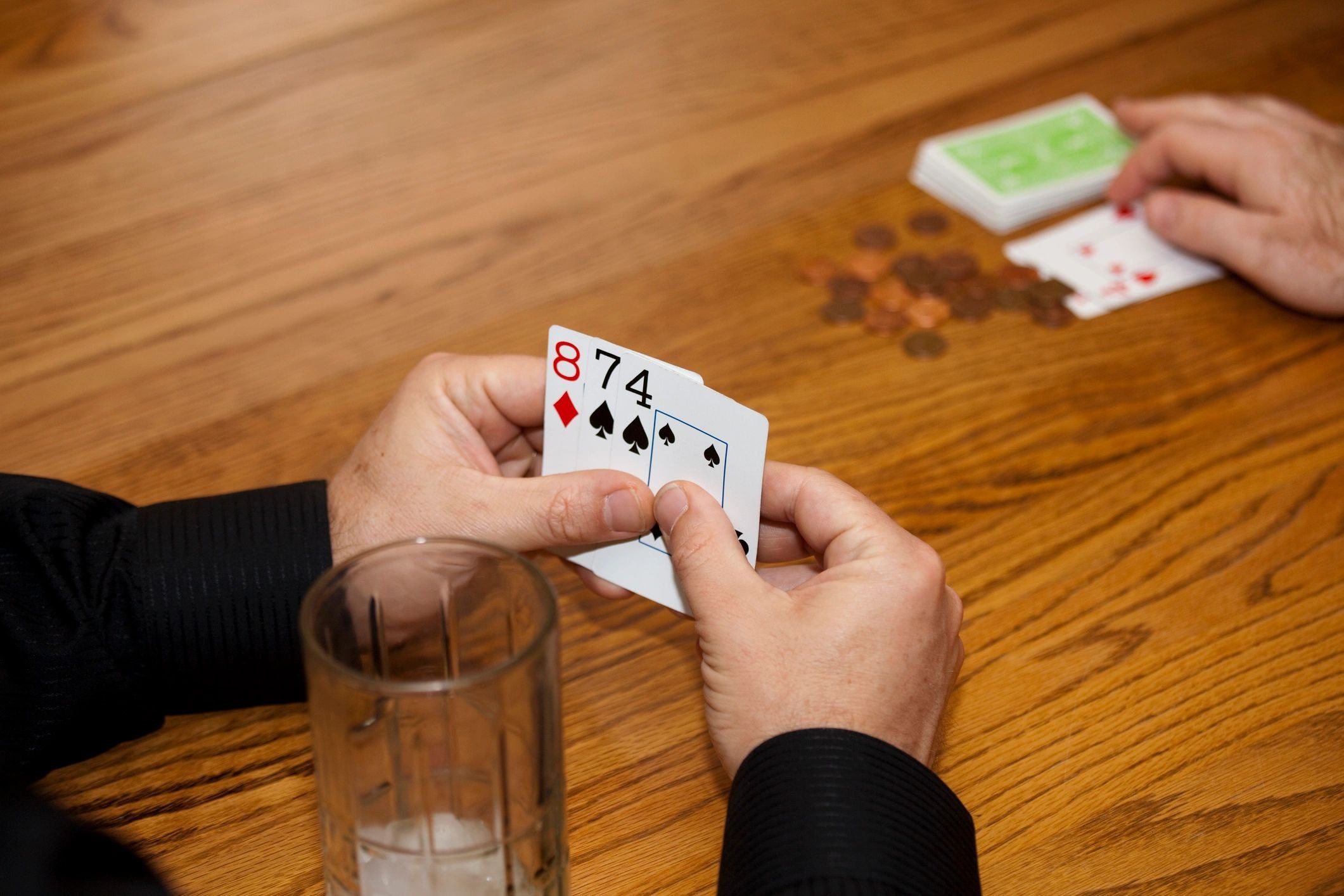 Close-up of hands holding playing cards